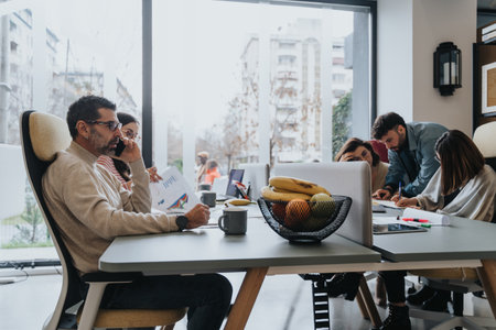 Multi generational coworkers strategizing for business growth, collaborating and sharing ideas at the office.の写真素材