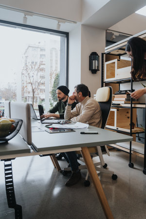 A business team discussing innovative business strategies in a collaborative office environment.の写真素材