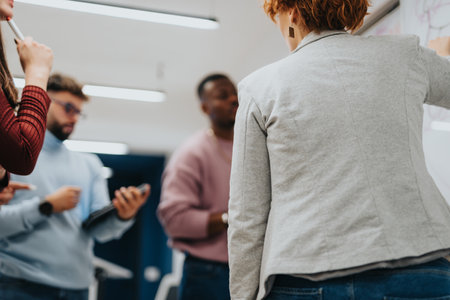 Collaborative brainstorming session with multiethnic colleagues in a modern officeの写真素材