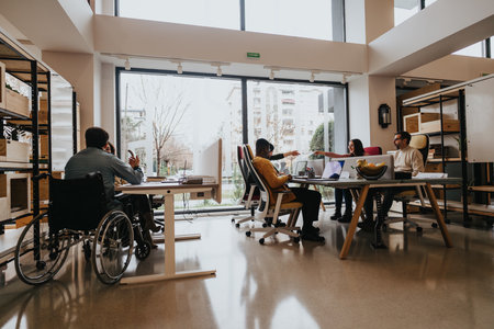 Contemporary office space with a multiethnic group of people working together. Includes a person...