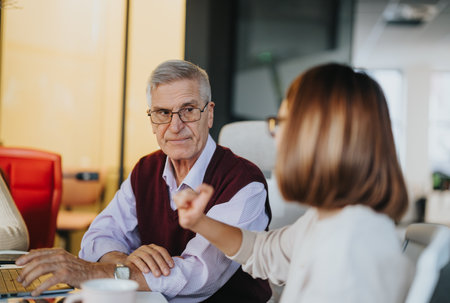 Multiethnic group of colleagues strategizing for business growth in office meeting.の写真素材