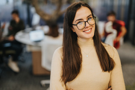 Successful businessperson standing proud in modern office.の写真素材