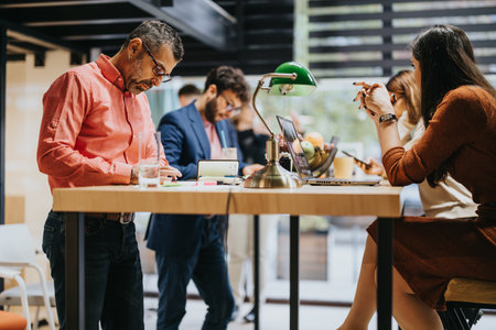 Diverse team analyzing data for business growth and client support in a creative office.