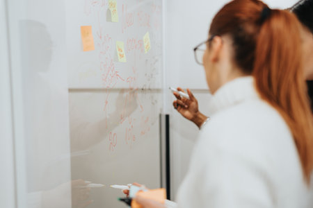 Creative colleagues brainstorming and discussing business expansion in a corporate officeの写真素材