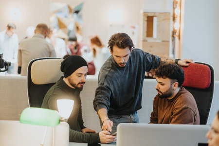 A collaborative workplace atmosphere between multiracial people is highlighted by teamwork and...
