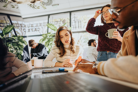Business meeting with multiethnic colleagues discussing brainstorming ideas and collaborating on a growth strategy.の写真素材