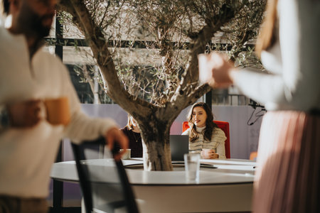 Diverse group in a corporate office collaborating on business expansion and growth strategy.の写真素材