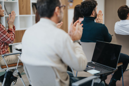 Participants in a corporate environment applauding after a successful presentation or workshop. A moment of appreciation and teamwork captured.の写真素材