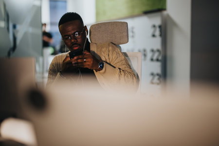 Good looking, black man watching tutorial before to keep solving project tasks at work.の写真素材