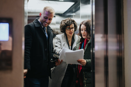 People reviewing documents together in modern office elevator.