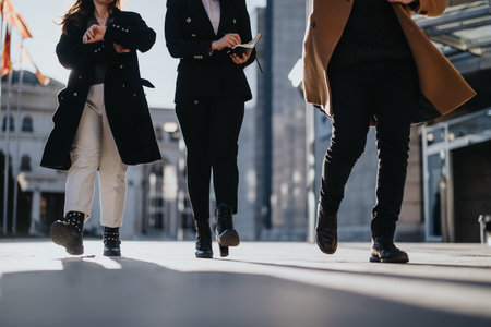Dynamic young entrepreneurs collaborating on business outdoors in the city.の写真素材
