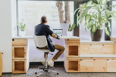 Senior businessman discussing ideas alone in a sunlit office.