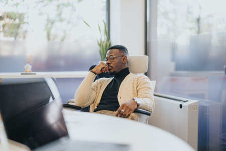 Male employee thinking of a solution at work.の写真素材