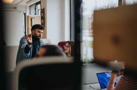 Engaged business team in a creative office meeting discussing ideas.の写真素材