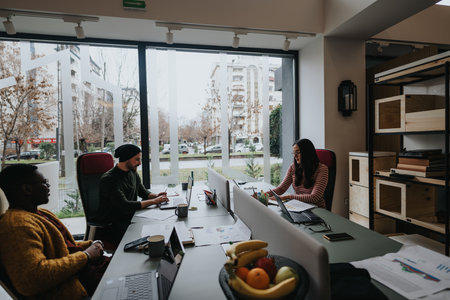 A multiethnic group of professionals working together in a well-lit office environment, featuring a...