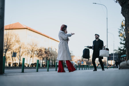 A businessman laden with bags catches up to his distracted girlfriend whos busy talking on the phone...