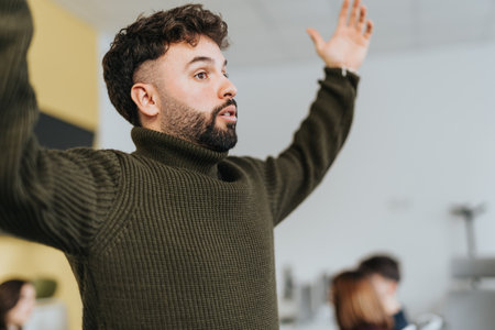 Business employee explaining something to his colleagues, gesturing with arms.の写真素材