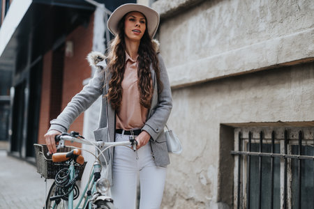Stylish woman with bicycle on urban street, fashion and active lifestyle concept.の写真素材