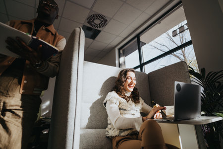 Collaborative colleagues enjoying a pleasant atmosphere while analyzing market data.の写真素材