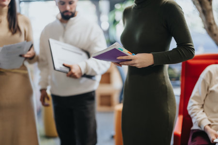 Business professionals brainstorming and discussing ideas in a vibrant co-working space.の写真素材
