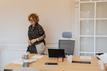 Senior woman about to take a break from work. She is leaving her workspace.