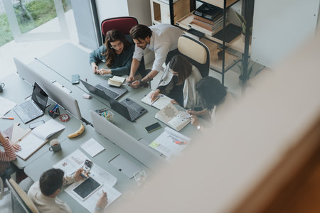 Successful diverse team of coworkers collaborating on project solutions in modern office.の写真素材