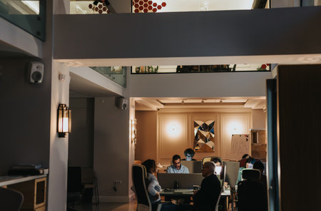Cross generational business professionals brainstorm, analyze, and collaborate in a late-night...