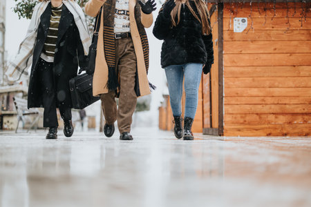 Professional business team walking together on snow-covered city sidewalk.