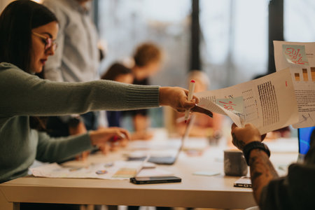 Collaborative team analyzing financial reports in a business meeting environment.の写真素材
