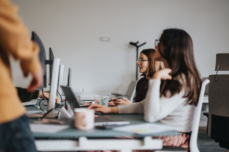 Confident business people collaborating in a creative corporate office, analyzing market data and strategizing for business growth and profitability.の写真素材
