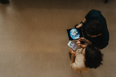 Top view photo of colleagues discussing innovation and strategy in the workplace using smart phone and tablet.の写真素材