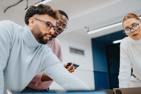 Creative collaboration in a corporate office: Colleagues discussing data analysis and market research for business expansionの写真素材