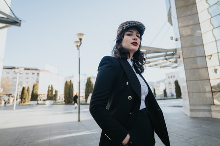 Confident female entrepreneur walking in urban setting for business matters.の写真素材