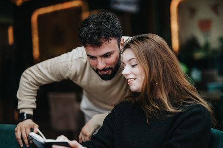 Casual business discussion with a happy male and female in a cozy setting.