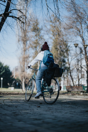 Active lifestyle concept. Rear view of person riding bicycle in park.の写真素材