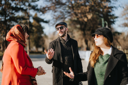 Multicultural team of business entrepreneurs discussing projects in sunny winter outdoors.