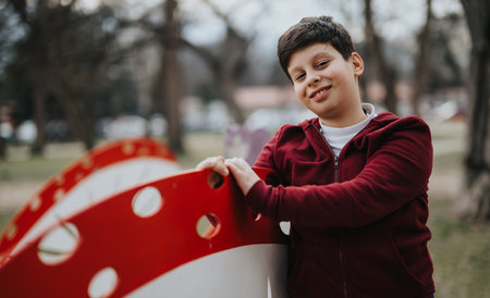 Young boy having fun with a bicycle at the park, joyful and active outdoorsの写真素材