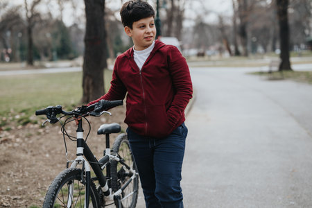 Young boy enjoying a day at the park with his bicycleの写真素材