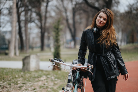 Confident businesswoman with bicycle in urban park, city lifestyle concept