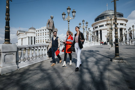 Young business professionals in discussion walking in a historic city centerの写真素材