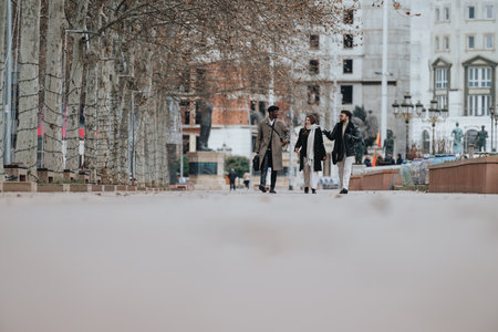 Young business professionals walking through city park for an informal meeting.の写真素材