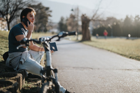 Man enjoying a break with his bicycle in a sunny park