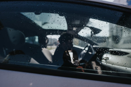 Rainy day car ride with a blurred driver at the wheel