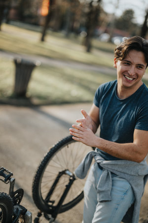 Casual young man enjoying a break during a bike ride in the park
