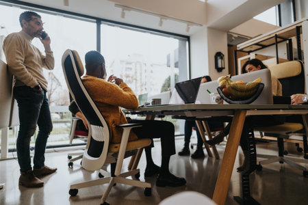 A dynamic office environment where a multiracial business team of colleagues collaborates.の写真素材