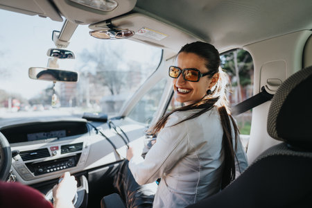 Professional businesswoman driving car, city commuteの写真素材