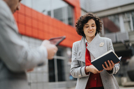 Business entrepreneurs meeting outdoors with digital tablet and planner