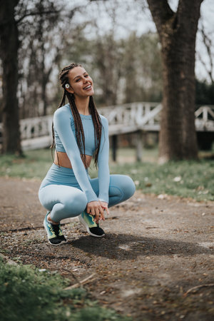 Fitness enthusiast doing a workout in a park, health and wellnessの写真素材