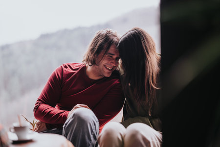 A couple sharing a quiet moment together at a cozy home setting.の写真素材