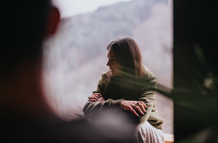 Casual conversation among friends in a cozy home environmentの写真素材